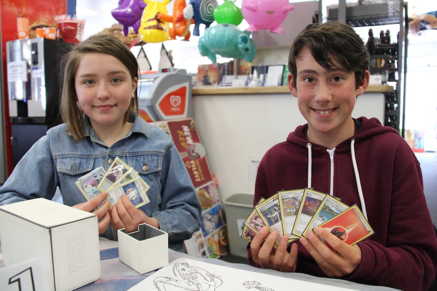 Isabella Wills and William Mooney with their Pokemon cards