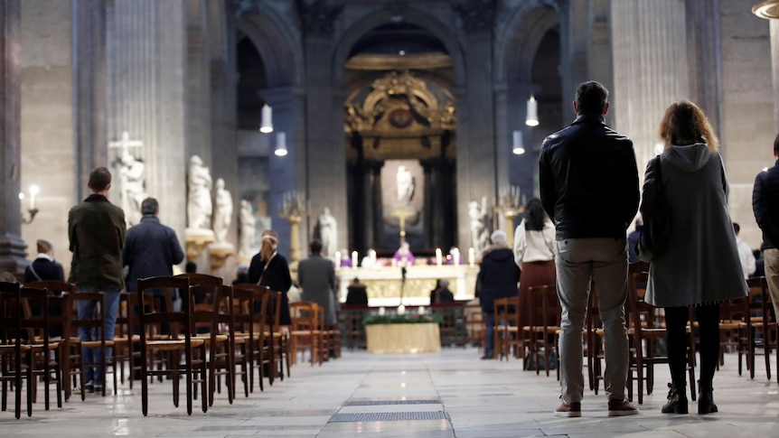 People attend mass at a Catholic church. 