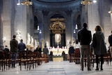 People attend mass at a Catholic church. 