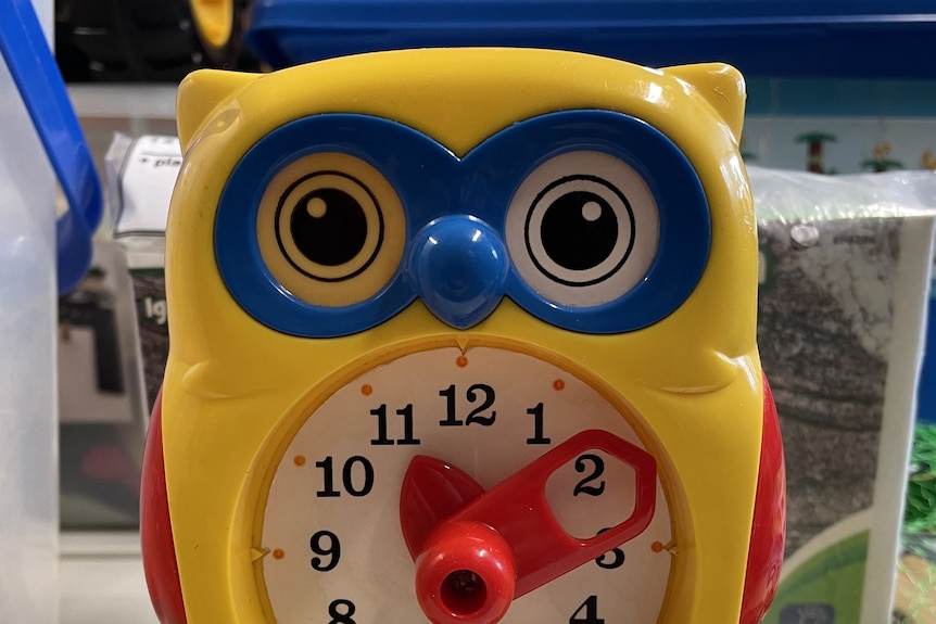 A yellow toy owl clock.