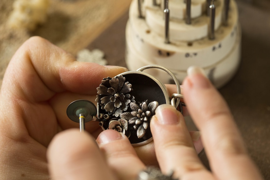 Jeweller adds the finishing touches to a pendant