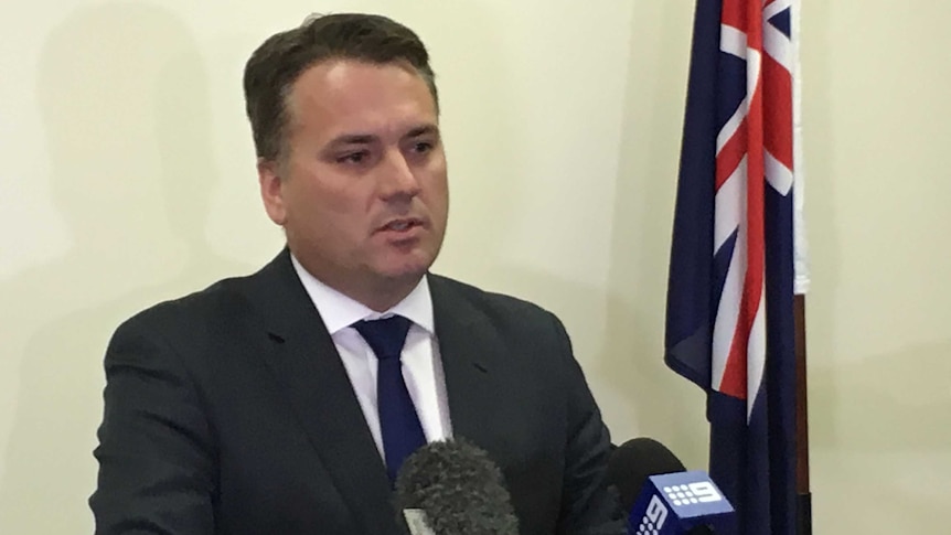 Jamie Briggs announces his resignation to media.