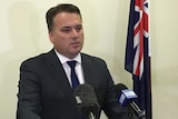 Jamie Briggs announces his resignation to media.