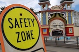A 'Safety Zone' sign sits next to the entrance to Luna Park in St Kilda.