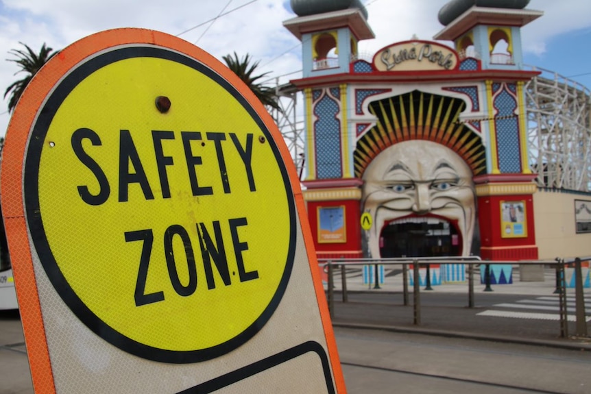 A 'Safety Zone' sign sits next to the entrance to Luna Park in St Kilda.