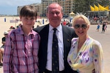 Martin Hamilton-Smith flanked by his son Thomas and wife Stavroula Raptis at a beach.