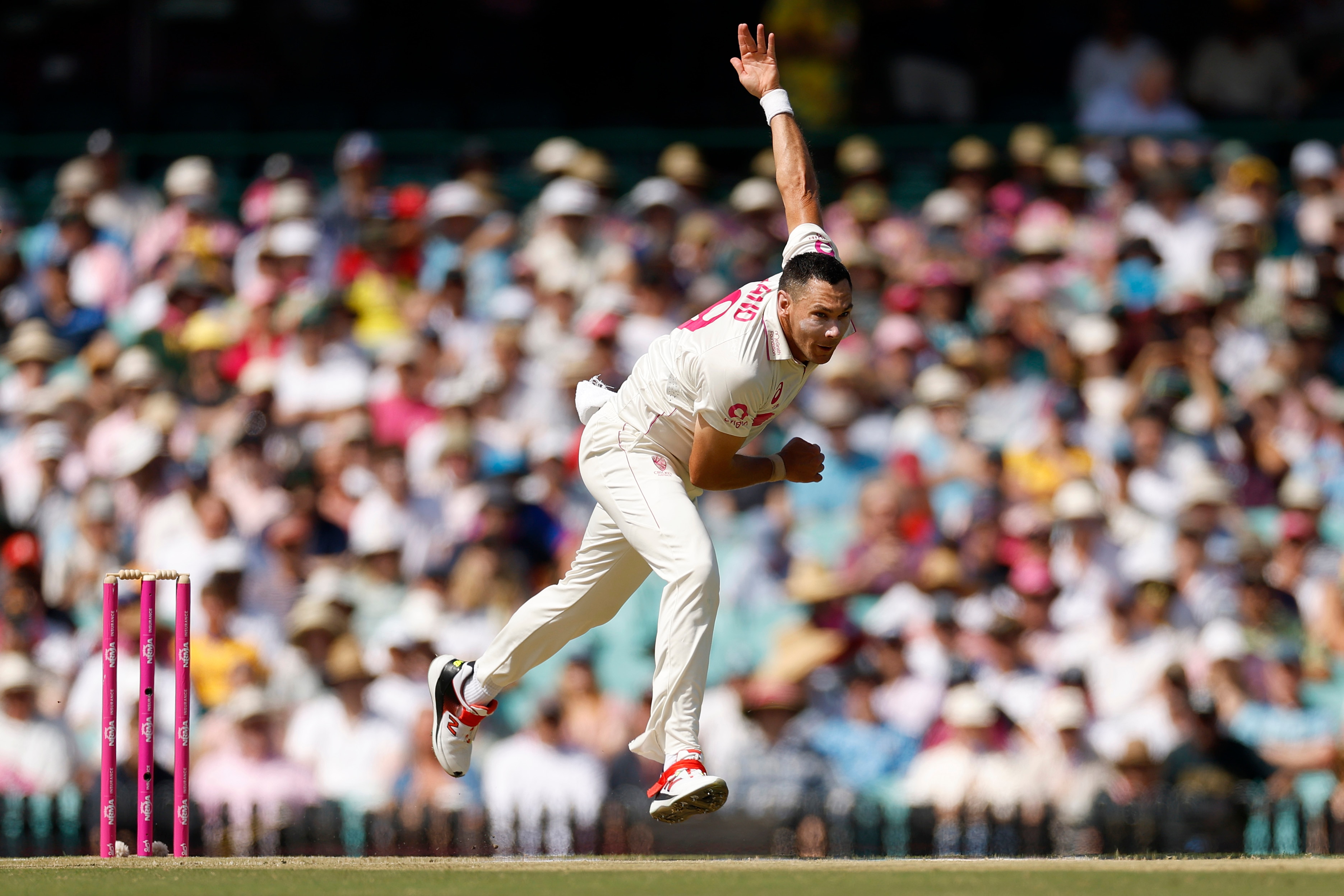 Australian pace bowler Scott Boland runs along the pitch after bowling a delivery in a Test match.