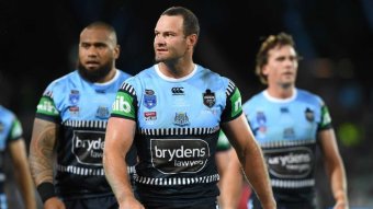 A NSW male State of Origin player walks ahead of two teammates during Game One against Queensland.