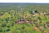 An aerial shot of a cattle station homestead amongst thick scrub.
