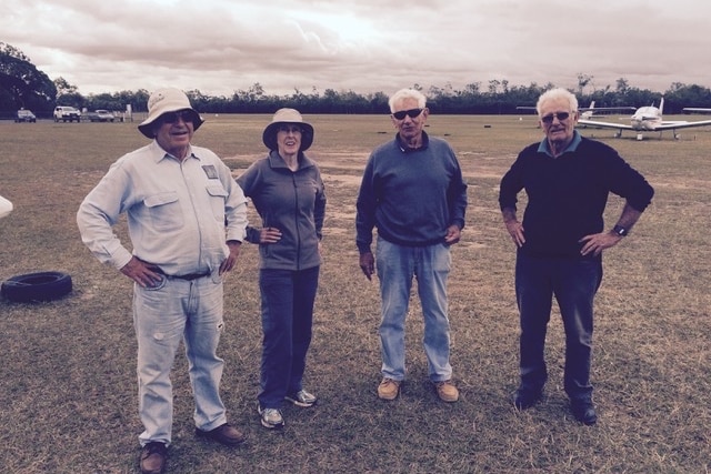 Christopher 'Bob' Turner (far right) stands alongside three other people on an airfield.