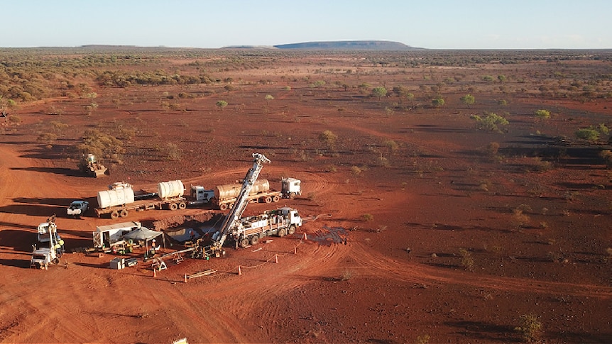 An aerial photo of a desert patch with mining equipment