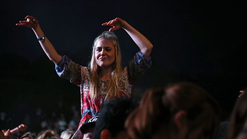 A girl on a person's shoulders at the Byron Bay Falls Festival