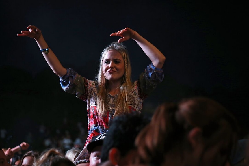 A girl on a person's shoulders at the Byron Bay Falls Festival