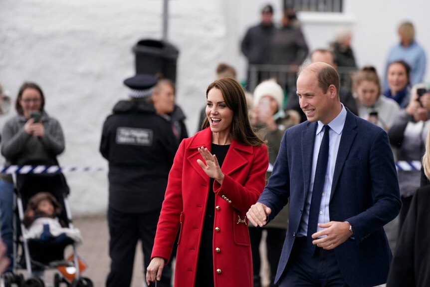 Kate and Will smile and wave at crowds.