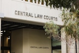 Signage on the side of the Central Law Courts building in Perth during the daytime.