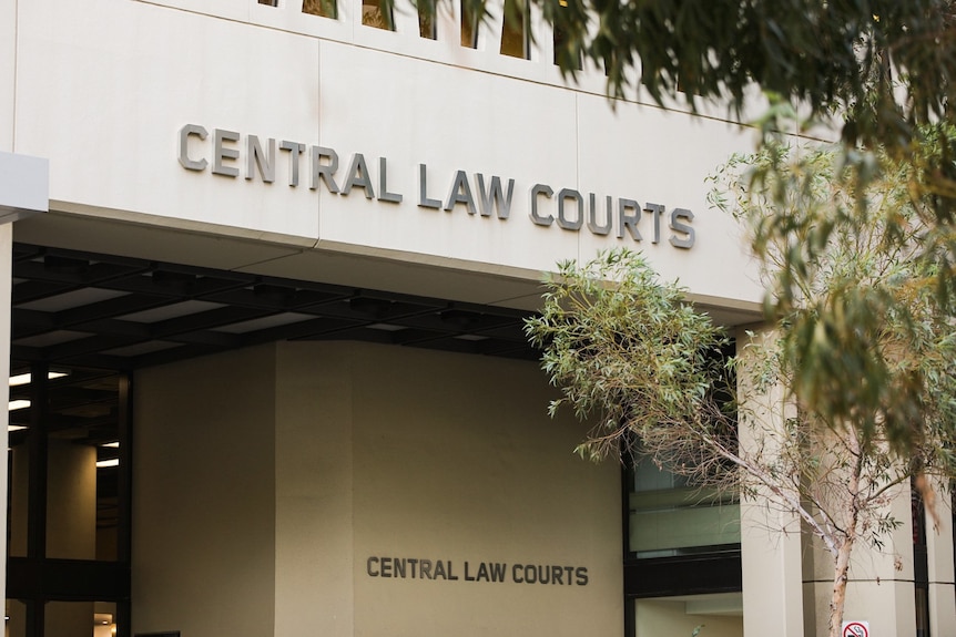 Signage on the side of the Central Law Courts building in Perth during the daytime.