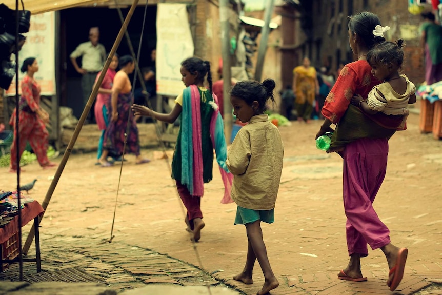 Children from lower castes walking in a slum