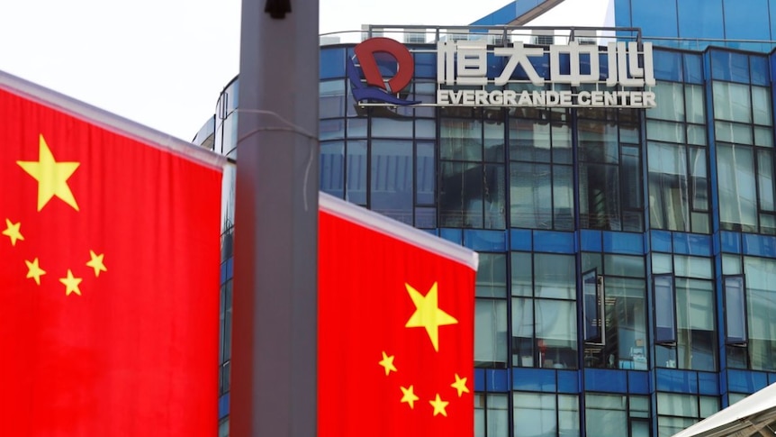 Chinese flag near the Evergrande Center logo in Shanghai, China, September 24, 2021.