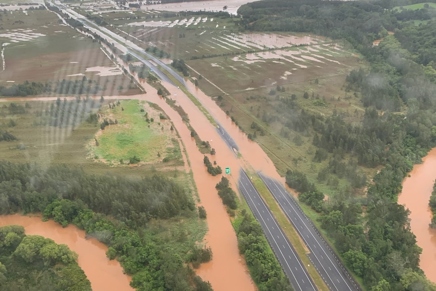 An aerial pic of a highway with floodwater over it.