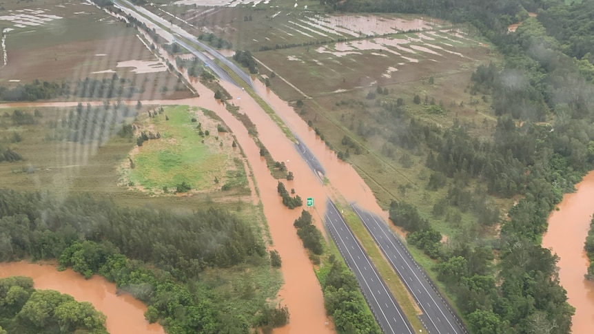 An aerial pic of a highway with floodwater over it.