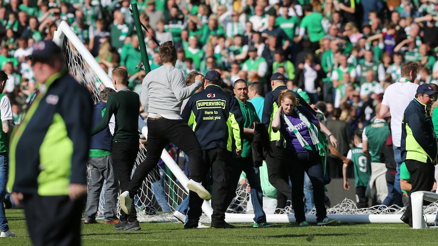 Hibernian fans on the pitch with the destroyed goal at end of Scottish Cup final against Rangers.