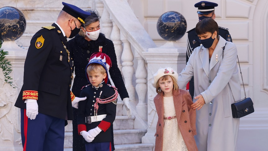 Part of Monaco's Royal family in formal dress, watching Monaco's National Day celebrations