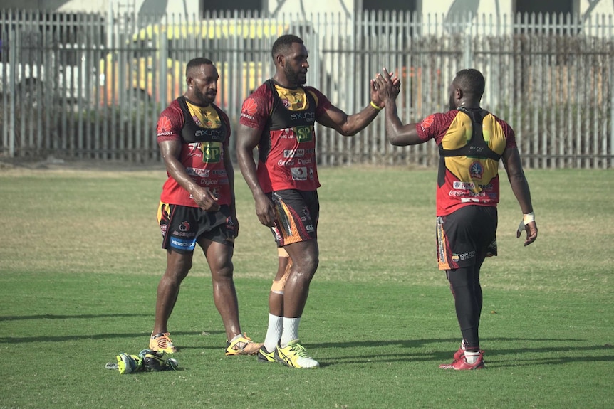PNG Hunters players high-five at training at the National Football Stadium in Port Moresby.