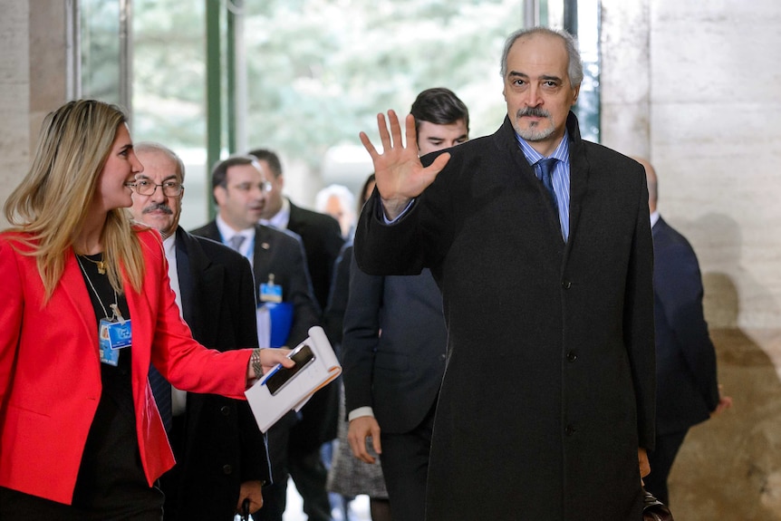 Bashar al-Jaafari gestures as he arrives for Syrian peace talks in Geneva.