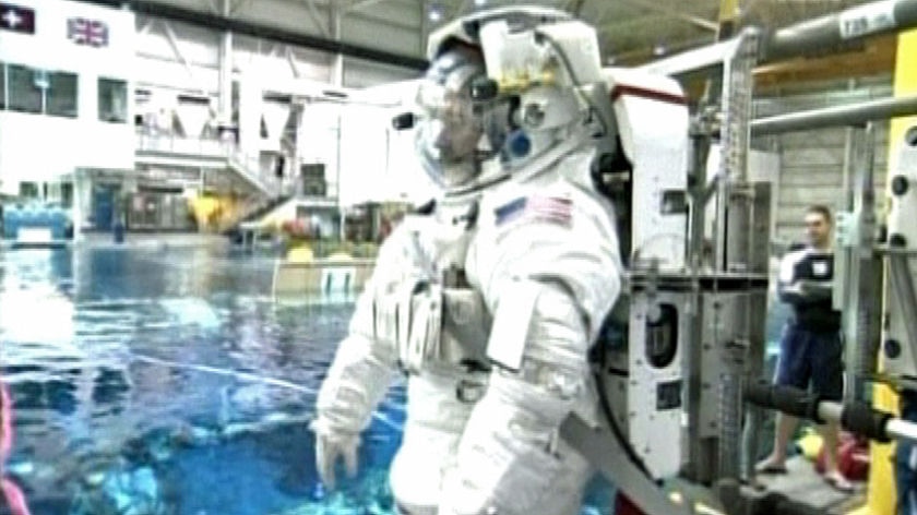 TV Still: NASA atsronaut in suit, training ahead of Hubble repairs mission.