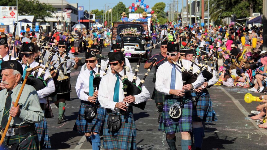 Pipers play during the parade at the Carnival of Flowers.