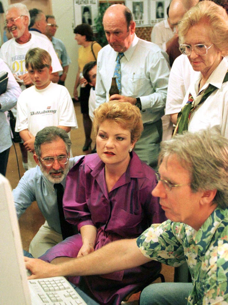 Pauline Hanson sits with One Nation supporters as votes come in.