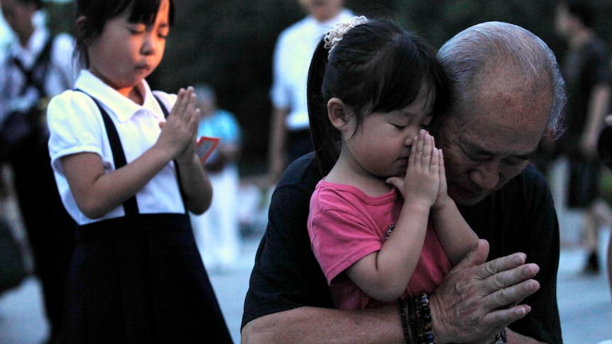 A family prays for Hiroshima bombing victims in Peace Memorial Park.