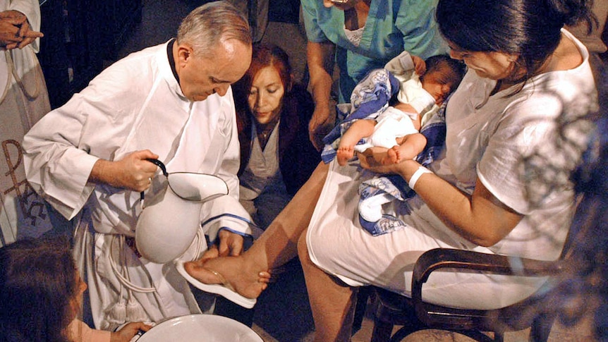 The archbishop of Buenos Aires, Cardinal Jorge Bergoglio, washes the feet of a unidentified woman.