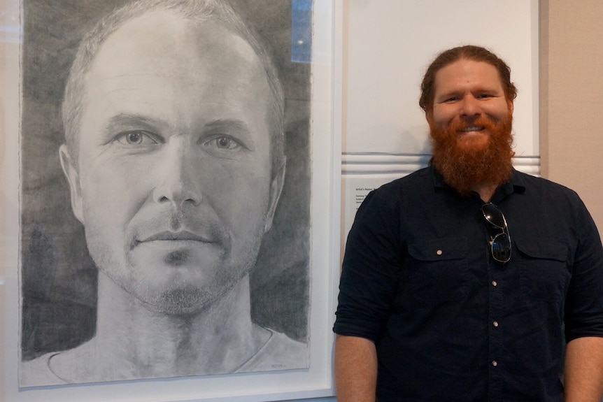Black Swan portraiture finalist Ross Potter with his painting of musician Carus Thompson