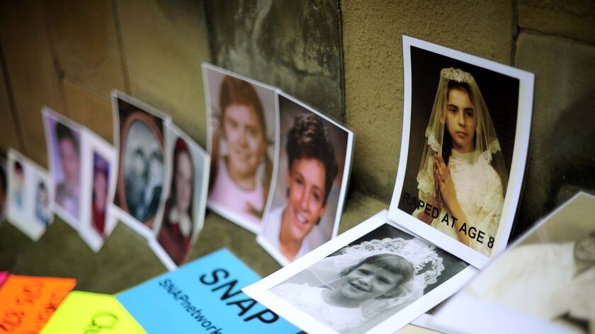 Photographs showing members of the US-based Survivors Network of those Abused by Priests (SNAP) are displayed during a protest outside Saint Mary's Metropolitan Cathedral in Edinburgh.