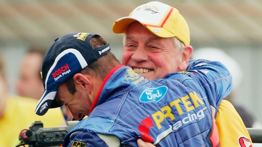 Marcos Ambrose celebrates back-to-back V8 Supercar titles with Dick Johnson in December 2004.