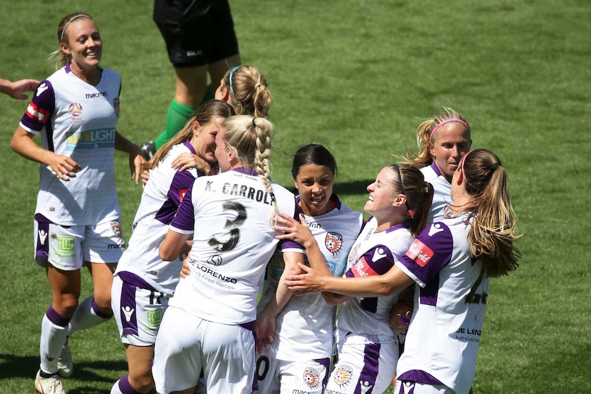 Goalscorer Sam Kerr is surrounded by her happy Perth Glory teammates in a W-League semi-final.