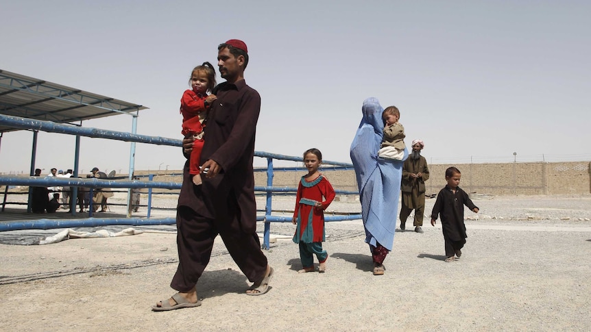 Afghan refugees arrive to be repatriated to Afghanistan, at the UNHCR office on the outskirts of Quetta, Pakistan.