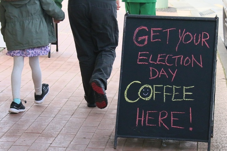 Cafe sign on the footpath advertising election day coffee