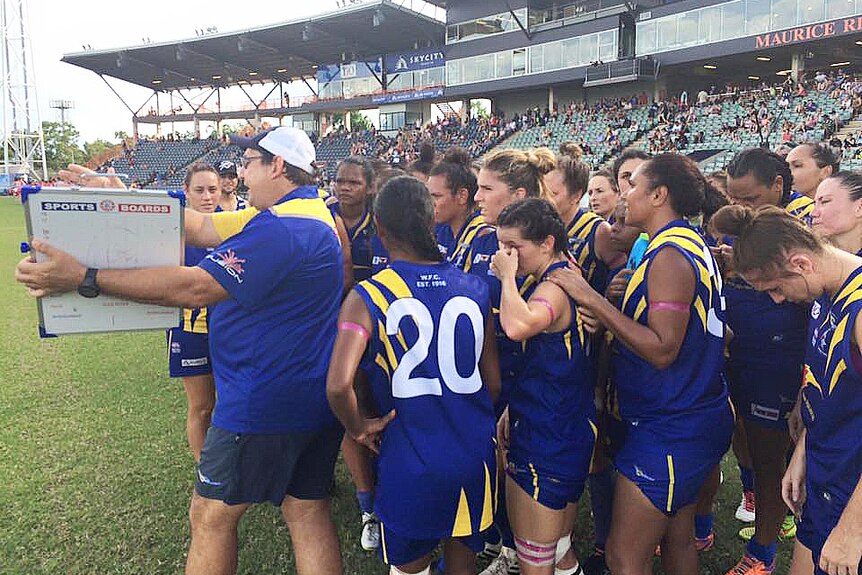 The Wanderers team listen to instructions during the 2016 Women's NTFL Grand Final.