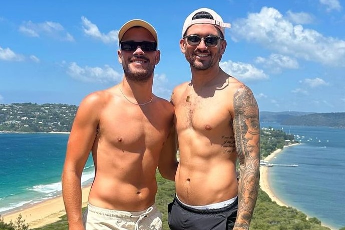 Jesse Baird and Luke Davies were allegedly killed seen here on a cliff wearing sunnies, caps no shirt overlooking a beach