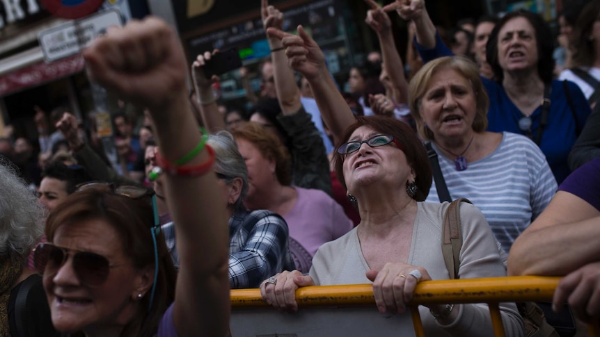 Women shout slogans during a protest outside the Justice Ministry in Madrid.