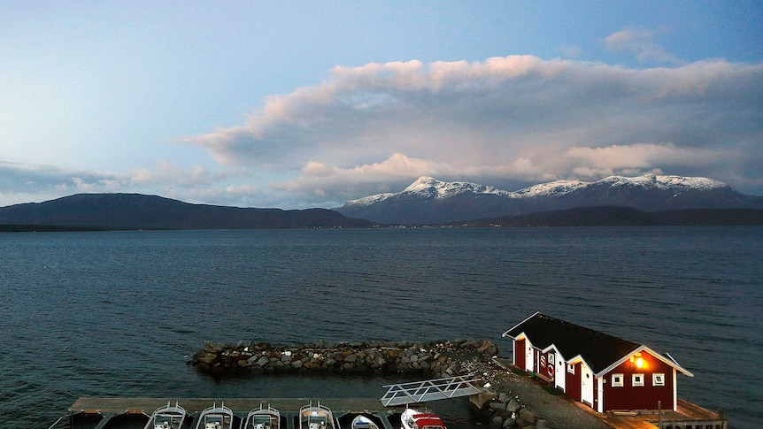 General view of a small harbour and snow-capped mountains in Bals-Fiord, north of the Artic Circle