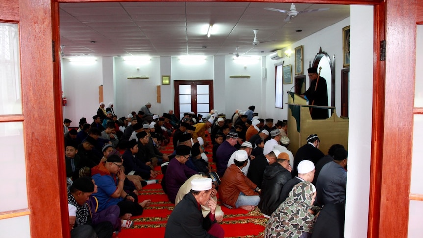 Muslim men praying in mosque