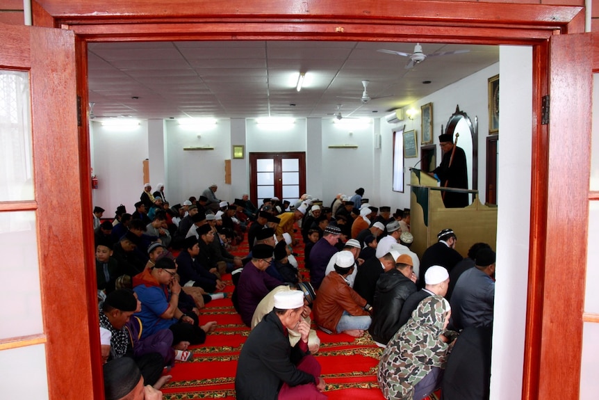 Muslim men praying in mosque