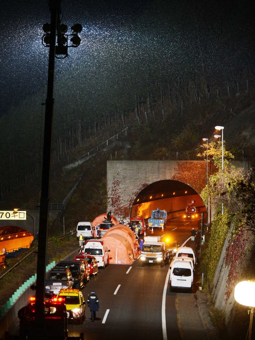 Snow falls as the rescue continues at the Sasago tunnel.
