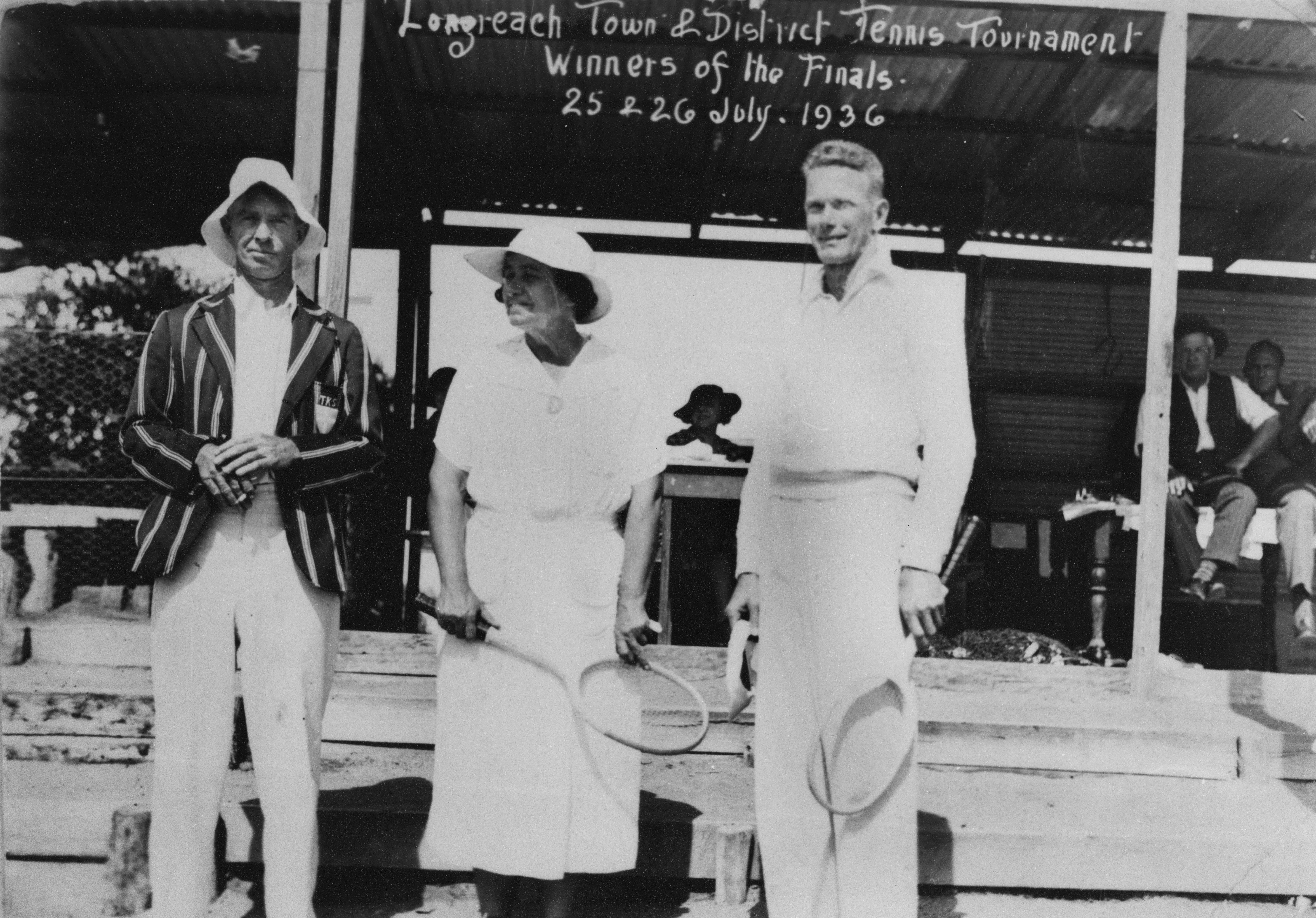 Black and white photo of three people holding tennis rackets
