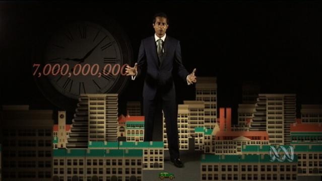 Jeremy Fernandez stands amongst model of a city