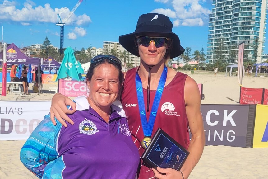 Katherine Bergemann-Cook hugs son Tom after he was named MVP in the under 16 national beach volleyball titles.