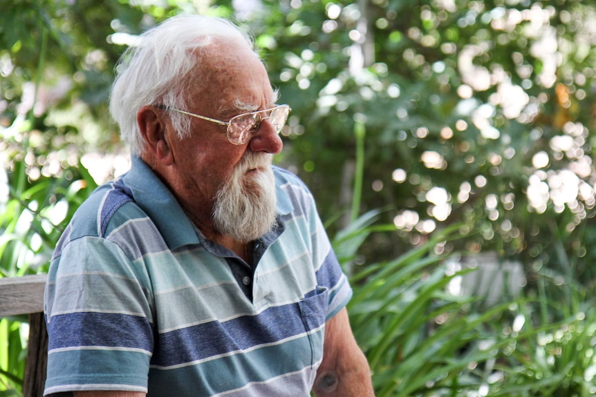 Wally Conron sits in his garden.